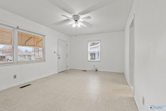 unfurnished room featuring ceiling fan and light tile patterned flooring