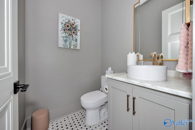 bathroom with vanity, toilet, and tile patterned floors