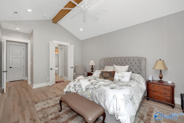 bedroom featuring lofted ceiling with beams, light hardwood / wood-style floors, and ceiling fan