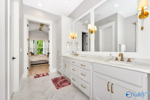 bathroom with ceiling fan, vanity, vaulted ceiling, and parquet floors