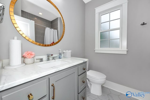 bathroom with a shower with curtain, vanity, toilet, and tile patterned floors