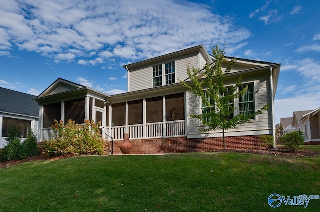 view of front of house featuring a front lawn and a sunroom