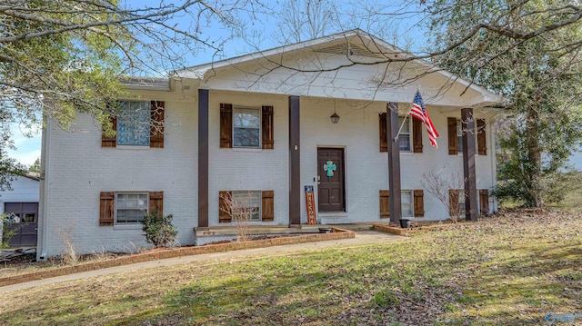 view of front of property with covered porch and brick siding