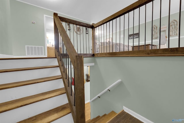 stairs with baseboards and visible vents