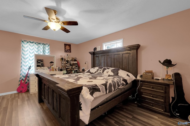 bedroom with wood finished floors, a ceiling fan, and baseboards