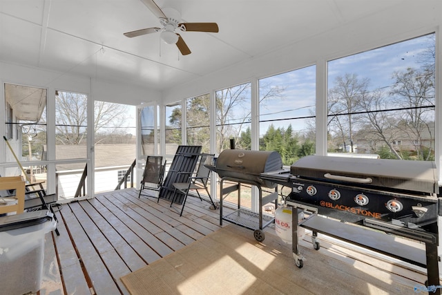 sunroom featuring a ceiling fan