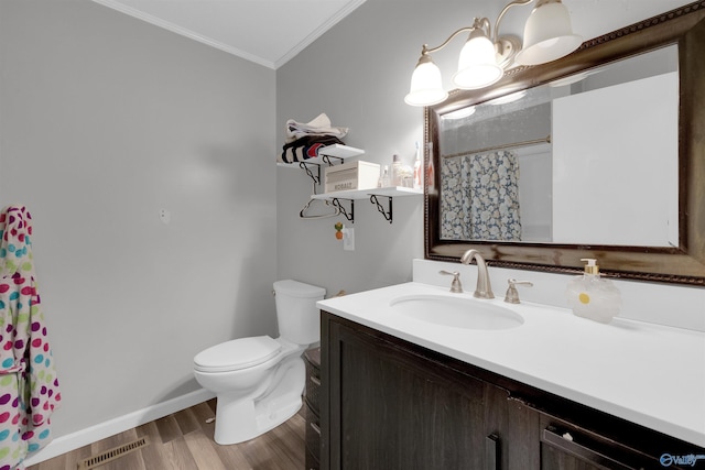 full bathroom featuring toilet, wood finished floors, vanity, visible vents, and ornamental molding