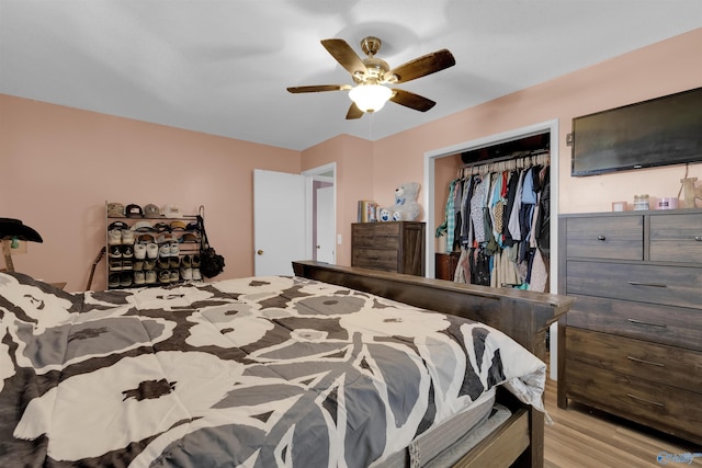 bedroom featuring ceiling fan, a closet, and wood finished floors