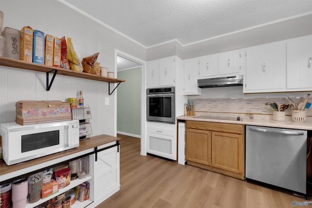 kitchen with open shelves, under cabinet range hood, light wood-style flooring, and stainless steel appliances