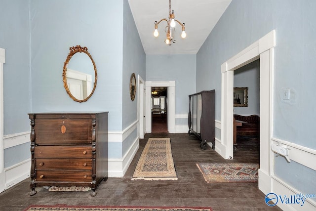 foyer with dark hardwood / wood-style floors and a chandelier