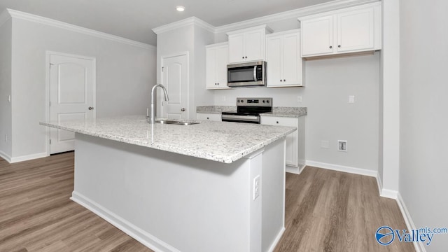 14 Moon Dr, Scottsboro, AL 35769 - kitchen featuring appliances with stainless steel finishes, a sink, wood finished floors, white cabinets, and ornamental molding