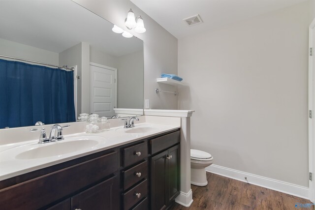 bathroom featuring baseboards, visible vents, a sink, and toilet