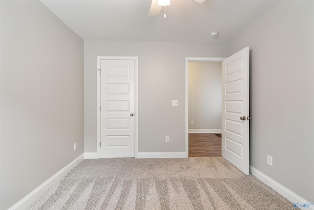 unfurnished bedroom featuring baseboards, ceiling fan, and carpet floors