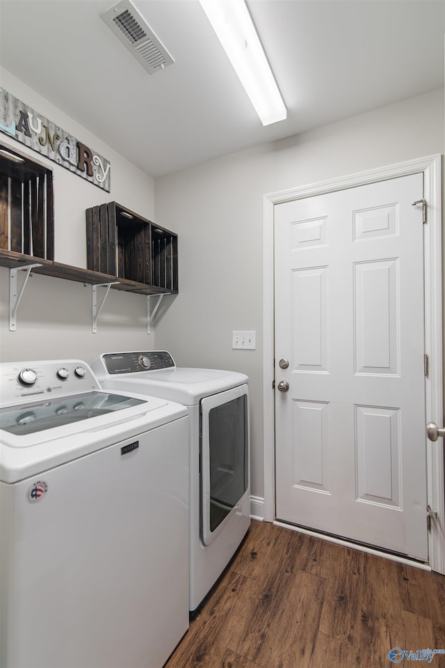 washroom with dark wood-style flooring, washer and dryer, laundry area, and visible vents