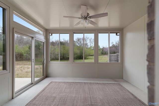 unfurnished sunroom with carpet flooring