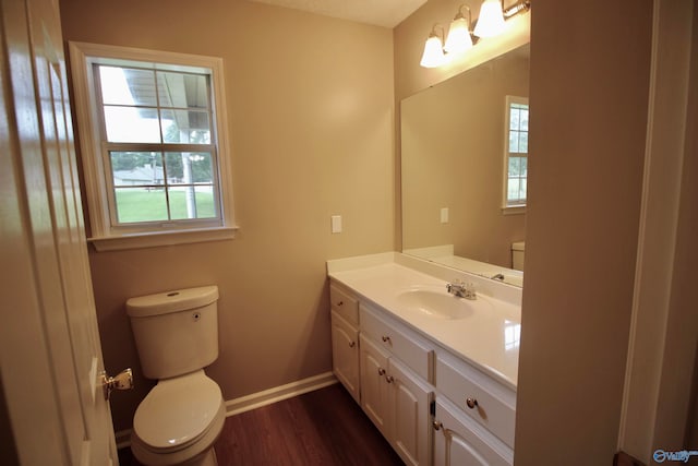 bathroom with vanity, toilet, and wood-type flooring