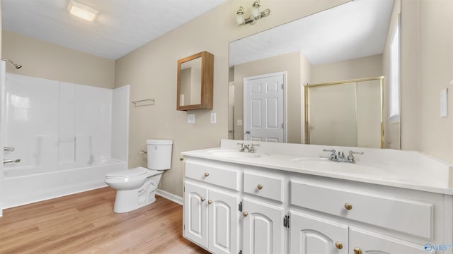 full bathroom featuring hardwood / wood-style floors, double vanity, shower / bathing tub combination, and toilet