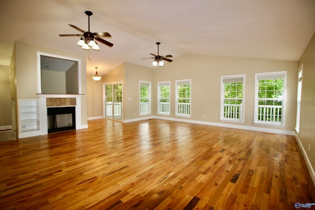 unfurnished living room with ceiling fan, lofted ceiling, light wood-type flooring, and a multi sided fireplace