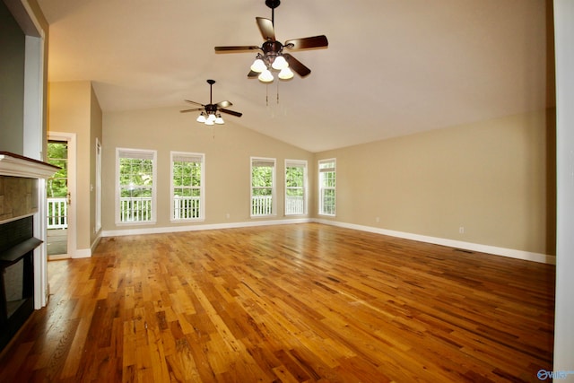 unfurnished living room featuring vaulted ceiling, light hardwood / wood-style flooring, and ceiling fan