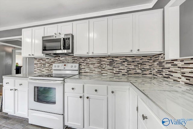 kitchen featuring white cabinetry, stainless steel microwave, and electric stove