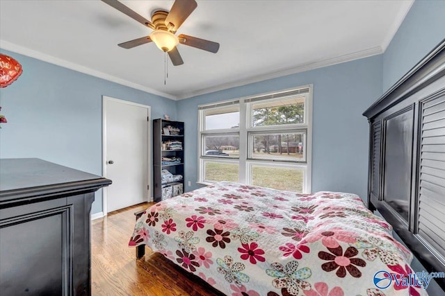 bedroom featuring ornamental molding, ceiling fan, and wood finished floors