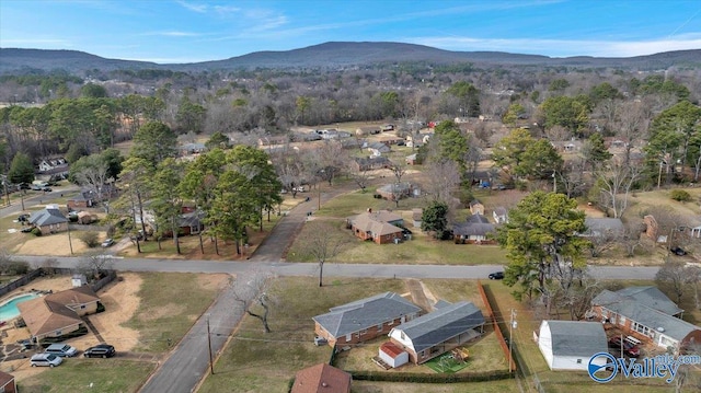 drone / aerial view featuring a mountain view and a wooded view