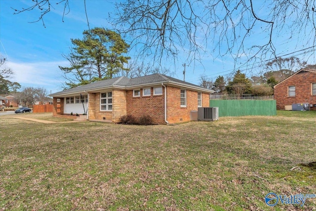 view of home's exterior featuring brick siding, crawl space, fence, and a lawn