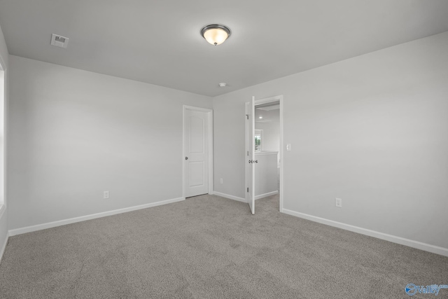 spare room with light colored carpet