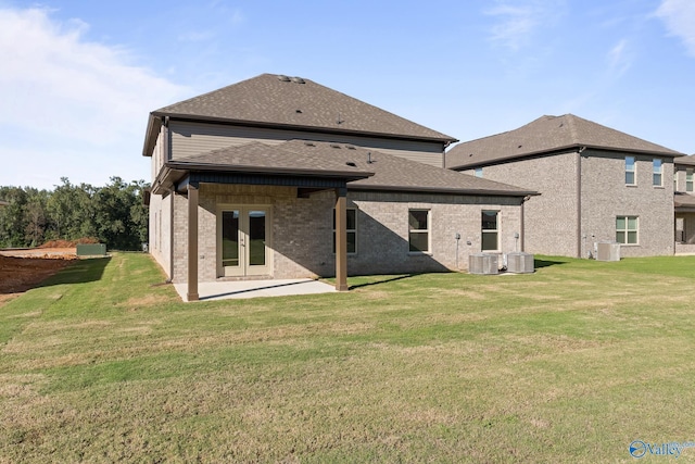 back of house featuring a lawn, a patio area, and central AC unit