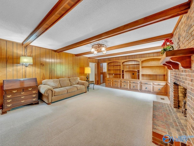 1913 Ruth St, Scottsboro, AL 35769 - carpeted living room with wooden walls, beamed ceiling, a fireplace, and a textured ceiling