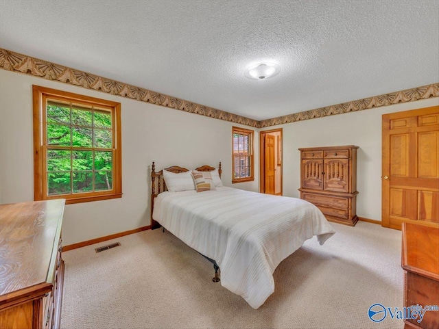 1913 Ruth St, Scottsboro, AL 35769 - bedroom featuring baseboards, light colored carpet, and visible vents