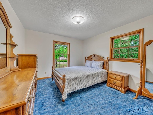 1913 Ruth St, Scottsboro, AL 35769 - carpeted bedroom featuring a textured ceiling and baseboards