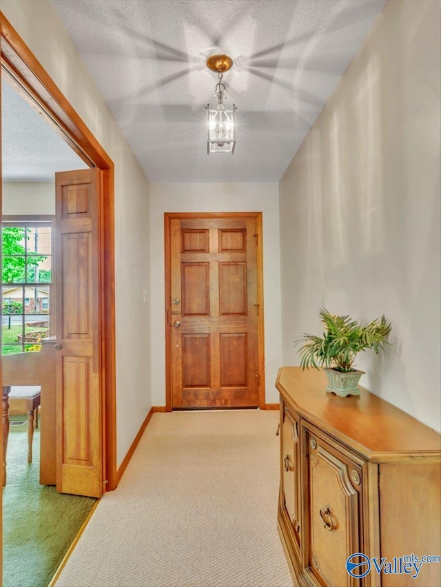 1913 Ruth St, Scottsboro, AL 35769 - interior space featuring a textured ceiling, light colored carpet, and baseboards