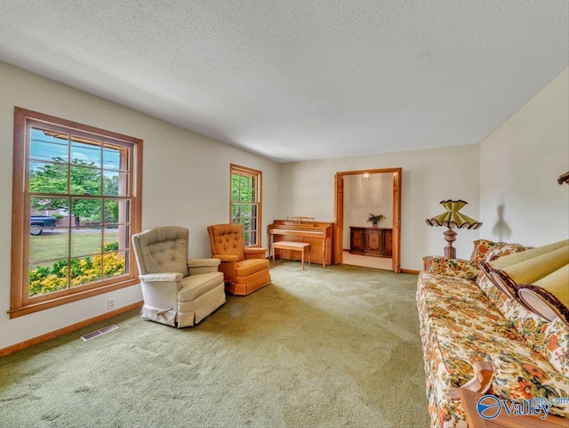 1913 Ruth St, Scottsboro, AL 35769 - living area with visible vents, a textured ceiling, carpet, and baseboards