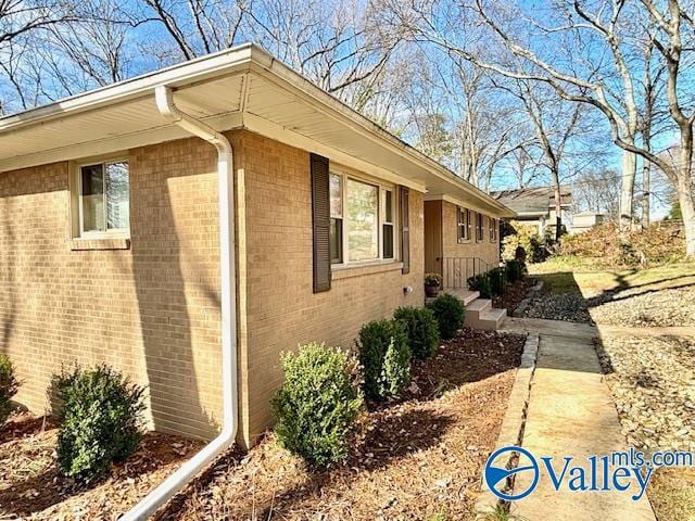 view of property exterior with brick siding