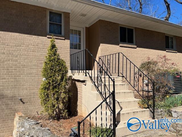 property entrance featuring brick siding