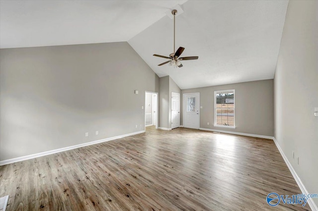 unfurnished living room with hardwood / wood-style flooring, ceiling fan, and high vaulted ceiling