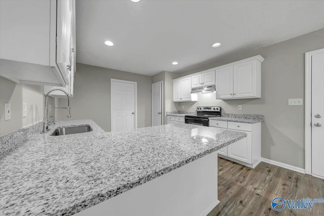 kitchen with sink, stainless steel electric range oven, light stone countertops, light hardwood / wood-style floors, and white cabinets