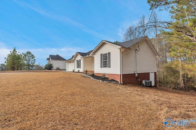 view of front facade with central AC and a garage