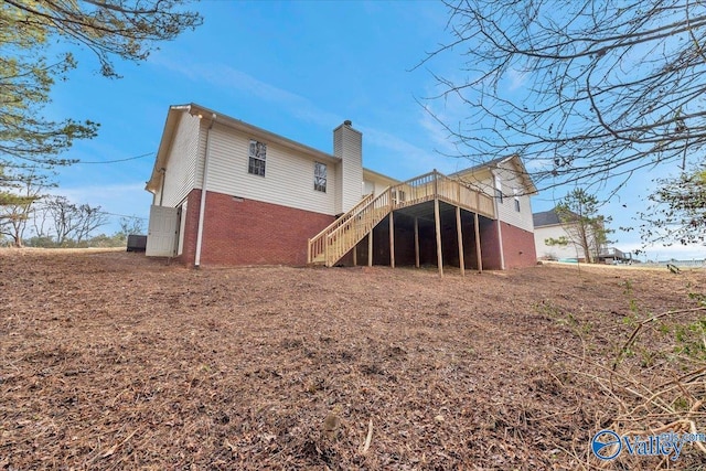 back of property featuring a wooden deck