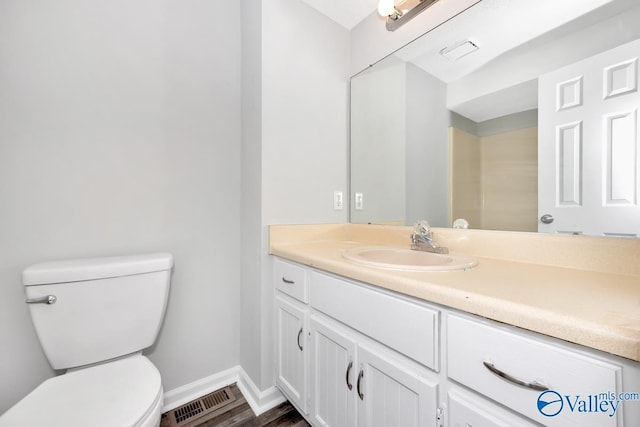 2007B Reaches Pl SW Unit B, Huntsville, AL 35802 - bathroom featuring toilet, vanity, baseboards, and wood finished floors