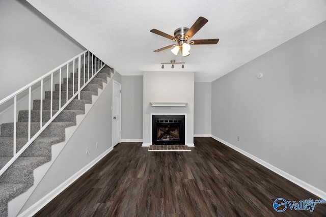 2007B Reaches Pl SW Unit B, Huntsville, AL 35802 - unfurnished living room with wood finished floors, a ceiling fan, stairs, baseboards, and a fireplace