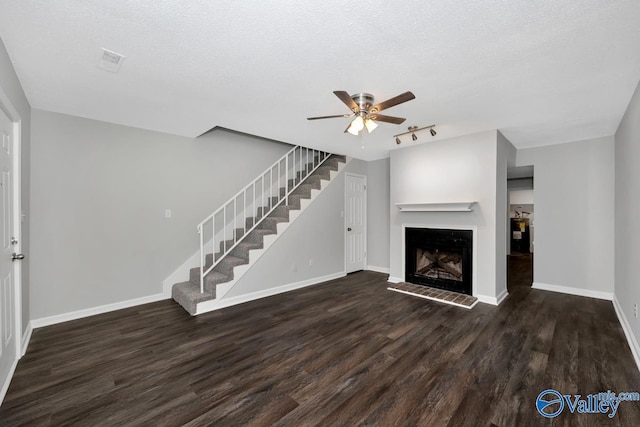 2007B Reaches Pl SW Unit B, Huntsville, AL 35802 - unfurnished living room featuring a ceiling fan, wood finished floors, stairs, baseboards, and a textured ceiling
