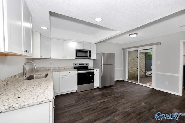 2007B Reaches Pl SW Unit B, Huntsville, AL 35802 - kitchen with stainless steel appliances, a sink, dark wood-style floors, white cabinets, and recessed lighting