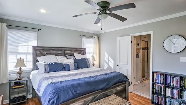 bedroom featuring ornamental molding, wood finished floors, and a ceiling fan