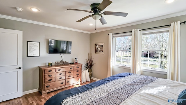 bedroom featuring light wood-style flooring, baseboards, and crown molding