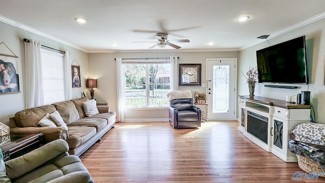 living area featuring a ceiling fan, recessed lighting, crown molding, and wood finished floors