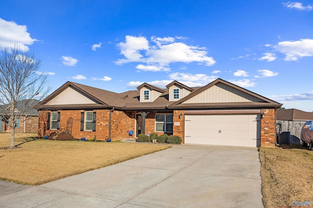 view of front of house with concrete driveway, a front yard, an attached garage, and brick siding