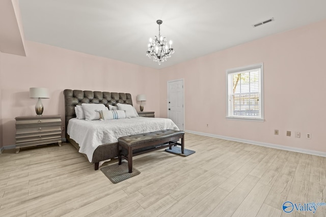 130 Kingswood Dr, Huntsville, AL 35806 - bedroom with baseboards, a notable chandelier, light wood-type flooring, and visible vents