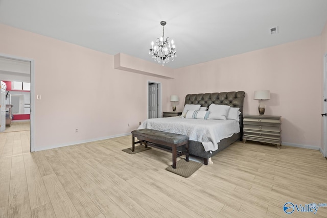 130 Kingswood Dr, Huntsville, AL 35806 - bedroom featuring visible vents, baseboards, light wood-type flooring, and an inviting chandelier